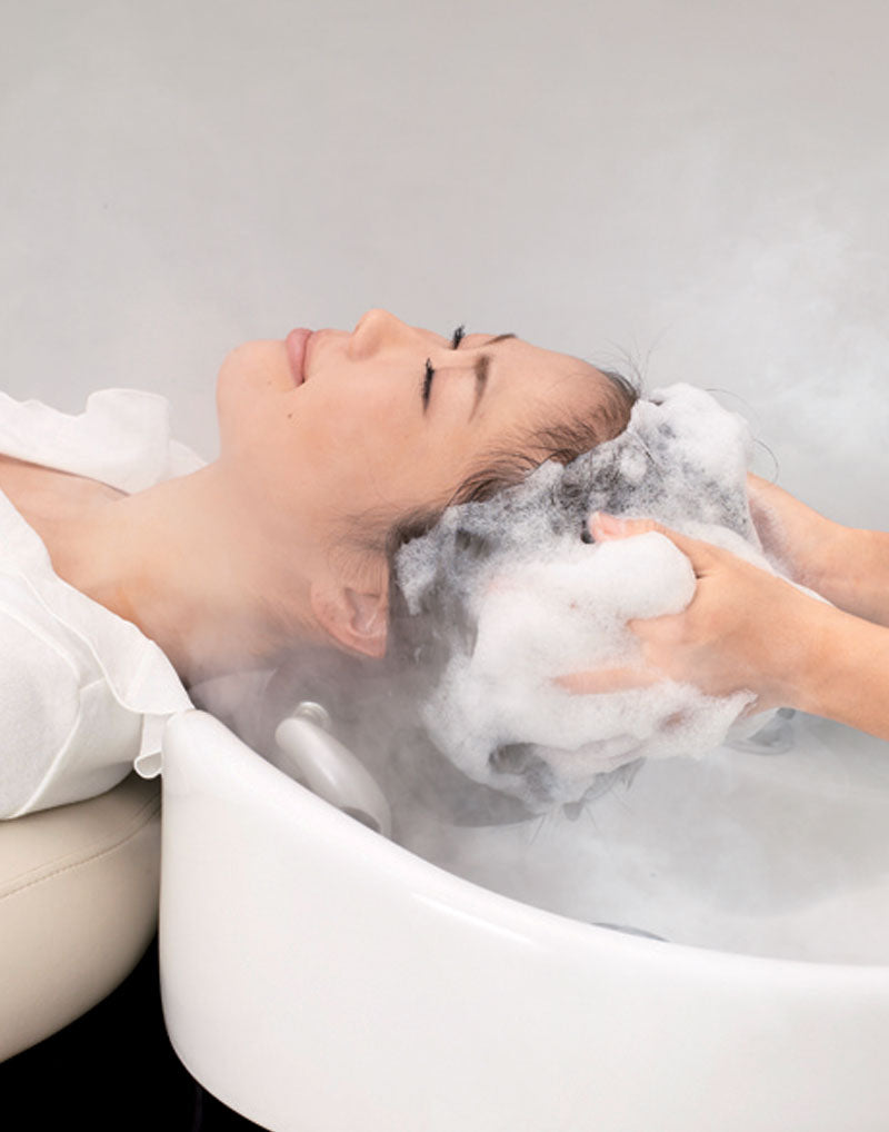 woman getting hair washed in a Yume shampoo bowl